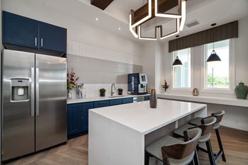 a kitchen with stainless steel appliances and a white counter top